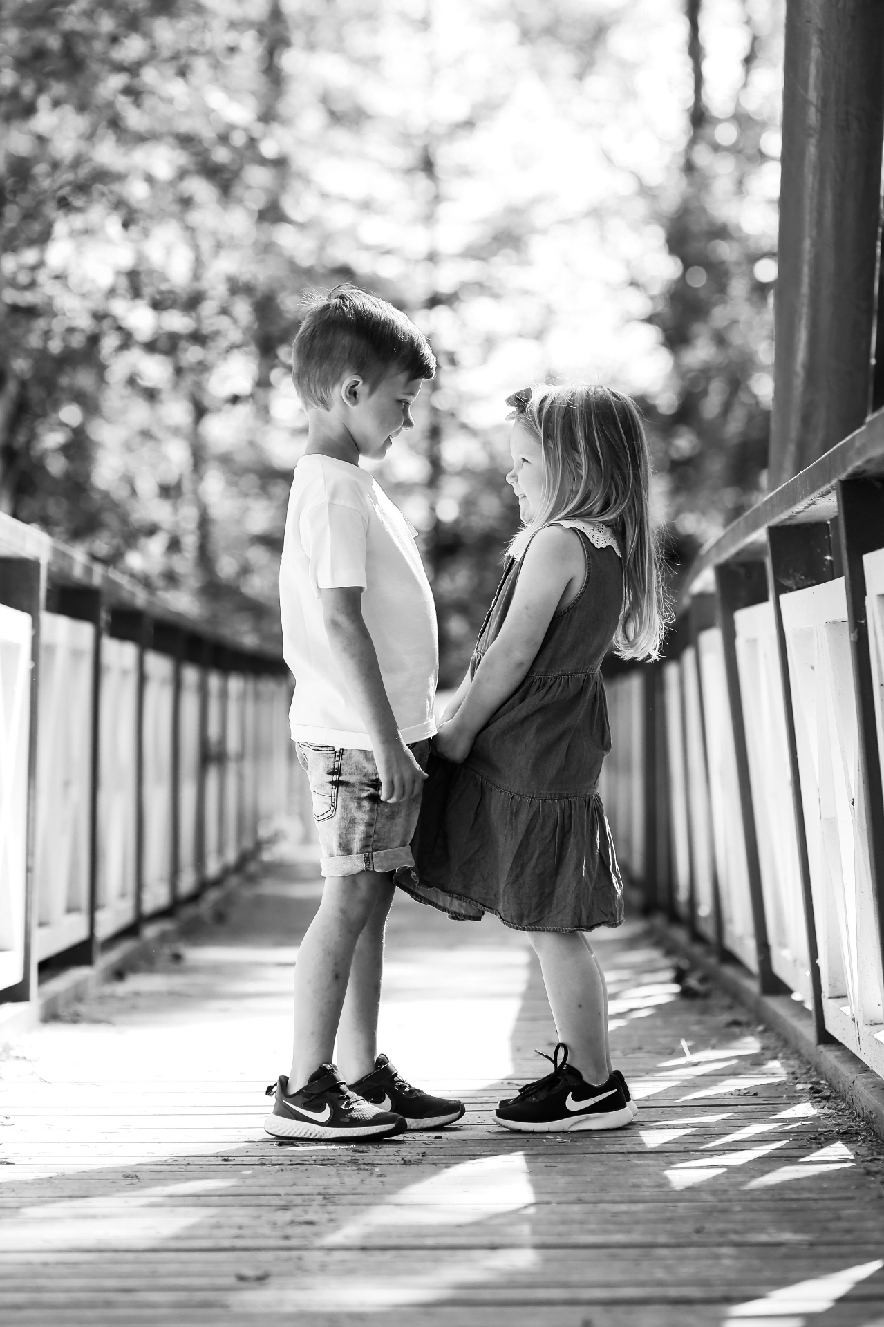 Two children on a wooden bridge