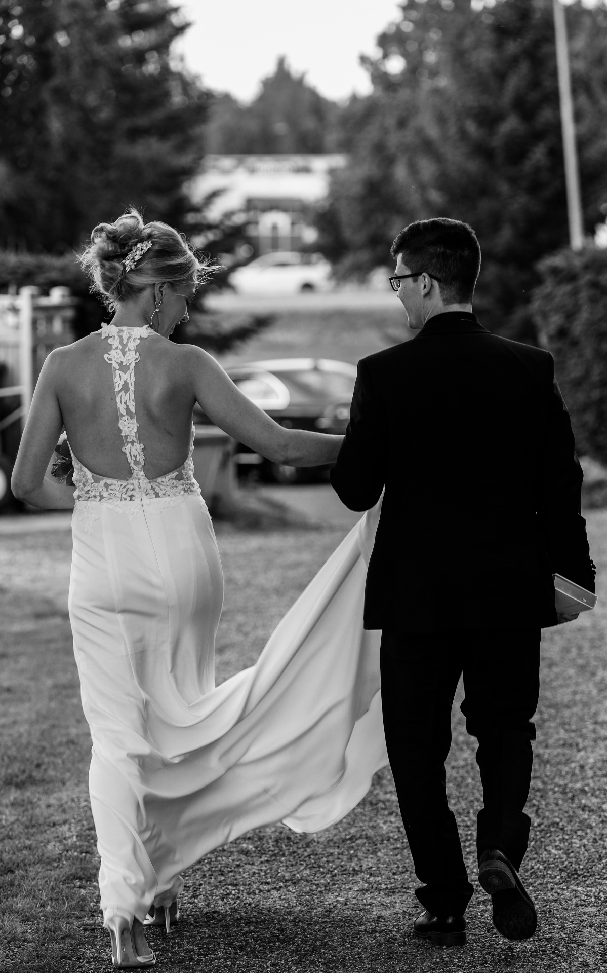 Bride and groom walking, dress trailing
