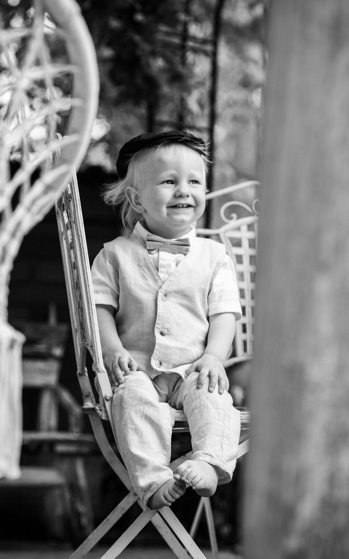 Ring bearer laughing on iron chair